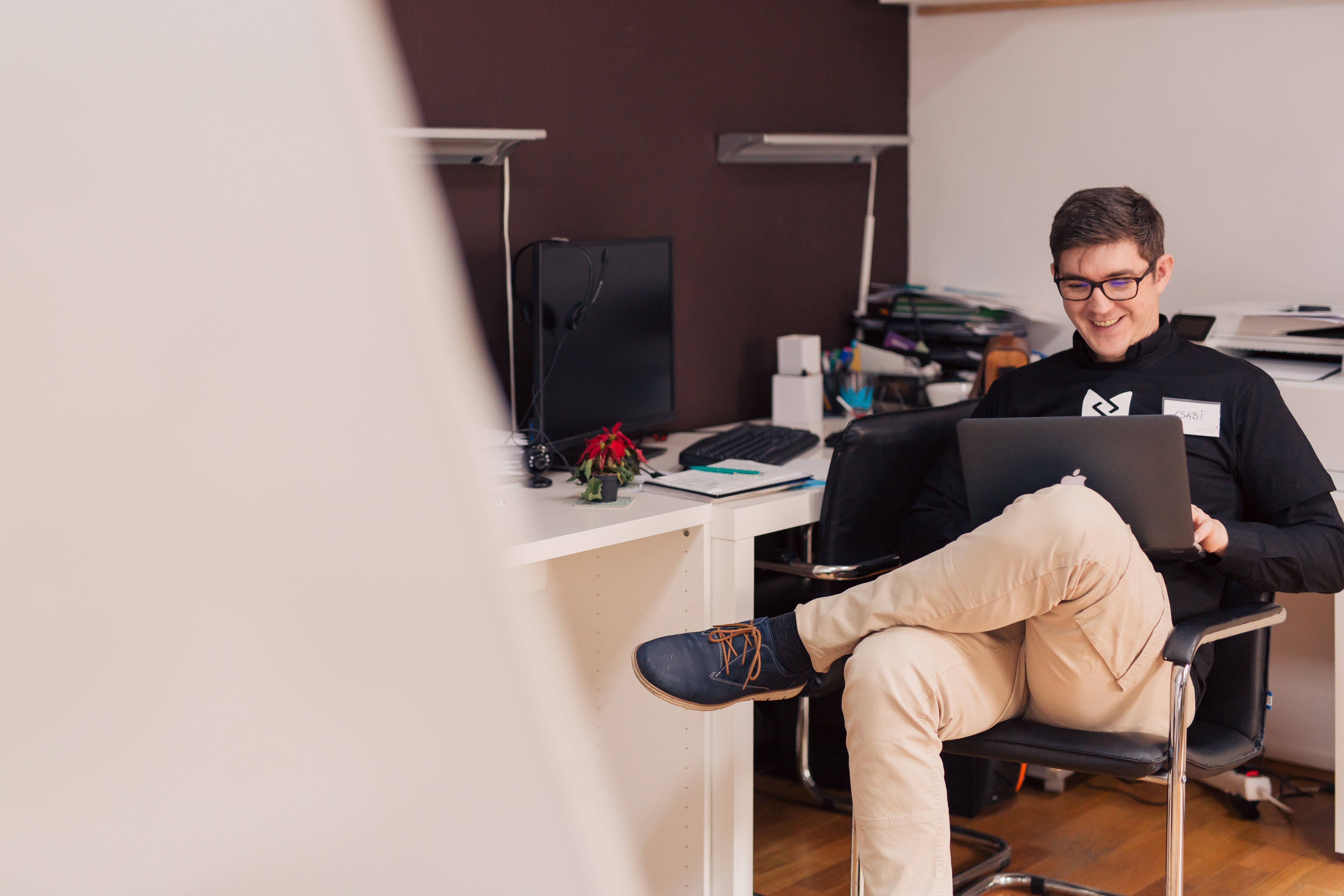 investor smiling while using laptop 